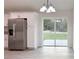 Bright kitchen and dining area with stainless steel refrigerator and sliding glass door at 3896 Sw 177Th Ter, Dunnellon, FL 34432