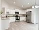 Bright kitchen with white cabinetry, stainless steel appliances, and granite countertops at 3896 Sw 177Th Ter, Dunnellon, FL 34432