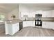 Bright kitchen features white cabinets, stainless steel appliances, and granite countertops at 3896 Sw 177Th Ter, Dunnellon, FL 34432