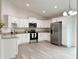 Bright kitchen with white cabinetry, stainless steel appliances, and granite countertops at 3896 Sw 177Th Ter, Dunnellon, FL 34432