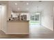 Modern kitchen with white cabinetry, breakfast bar, and sliding glass doors to the backyard at 3896 Sw 177Th Ter, Dunnellon, FL 34432