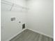 Laundry room featuring new vinyl flooring, washer dryer hookups and a wire shelf at 3896 Sw 177Th Ter, Dunnellon, FL 34432