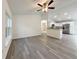 Open floor plan with views of the kitchen featuring stainless appliances and white cabinetry at 3896 Sw 177Th Ter, Dunnellon, FL 34432