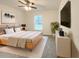 Comfortable bedroom with natural-toned decor, a wooden bed frame, ample natural light, and a ceiling fan at 3896 Sw 177Th Ter, Dunnellon, FL 34432