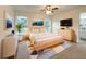 Beautifully staged main bedroom with large windows, ceiling fan, and contemporary decor at 3896 Sw 177Th Ter, Dunnellon, FL 34432
