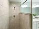 Modern walk-in shower featuring neutral tile and a glass partition to the bathroom at 3896 Sw 177Th Ter, Dunnellon, FL 34432