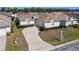 An aerial view of a house with a curved driveway and trimmed landscaping in a quiet neighborhood at 5891 Nw 26Th St, Ocala, FL 34482
