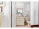Well-lit bathroom featuring a vanity with marble countertop, a toilet, and a window with blinds at 5891 Nw 26Th St, Ocala, FL 34482