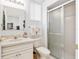 Bathroom featuring a vanity, toilet, and a glass-enclosed shower, illuminated by modern lighting at 5891 Nw 26Th St, Ocala, FL 34482