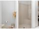 Neutral-toned bathroom featuring a walk-in shower with a built-in seat and tiled walls at 5891 Nw 26Th St, Ocala, FL 34482