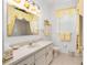 Bright bathroom featuring a single sink vanity, decorative mirror and matching yellow accents at 5891 Nw 26Th St, Ocala, FL 34482