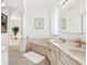 Well-lit bathroom featuring a soaking tub, double vanity, columns, and neutral tones at 5891 Nw 26Th St, Ocala, FL 34482