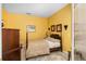 Cozy bedroom with yellow walls, a patterned bedspread, and natural light at 5891 Nw 26Th St, Ocala, FL 34482