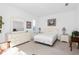 A bright bedroom featuring a light color palette, a stylish dresser, and ample natural light at 5891 Nw 26Th St, Ocala, FL 34482
