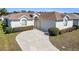 Beautiful home with a well-maintained lawn, a curved driveway leading to a two-car garage at 5891 Nw 26Th St, Ocala, FL 34482