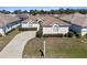 Charming single-story home featuring a well-manicured lawn, a curved driveway, and a welcoming entrance at 5891 Nw 26Th St, Ocala, FL 34482