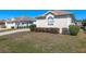 Well-maintained single-story home with arched windows, a curved driveway, and lush landscaping at 5891 Nw 26Th St, Ocala, FL 34482