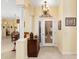 Welcoming foyer featuring a decorative cabinet, pillars, and access to the living spaces at 5891 Nw 26Th St, Ocala, FL 34482