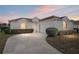 Charming single-story home with a well-manicured lawn, arched windows, and a spacious driveway at 5891 Nw 26Th St, Ocala, FL 34482