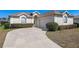 Charming single-story home with a well-manicured lawn, arched windows, and a spacious driveway at 5891 Nw 26Th St, Ocala, FL 34482