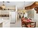 Bright kitchen and eat-in kitchen showcasing white cabinets and appliances, with natural light and decorative accents at 5891 Nw 26Th St, Ocala, FL 34482