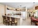 Bright kitchen with a breakfast bar, white cabinets, and easy access to the dining area at 5891 Nw 26Th St, Ocala, FL 34482
