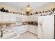 Bright and airy kitchen featuring white cabinets, a built-in microwave, and plenty of counter space at 5891 Nw 26Th St, Ocala, FL 34482