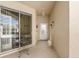 Covered and screened-in lanai, featuring a view of the backyard, a small table, and a sliding glass door at 5891 Nw 26Th St, Ocala, FL 34482