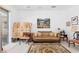 Living room with large window offering natural light and stylish sofa seating at 5891 Nw 26Th St, Ocala, FL 34482