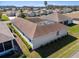 Back of house boasts manicured landscaping with charming white exterior and a spacious yard at 5891 Nw 26Th St, Ocala, FL 34482