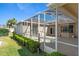A screened patio extends from the home into a green lawn and features a sliding door and a view of the backyard at 5891 Nw 26Th St, Ocala, FL 34482