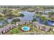 Aerial view shows a community with a pool surrounded by mature trees and beautiful lakeside views at 615 Midway Dr # B, Ocala, FL 34472