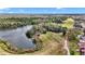 Expansive view of a community next to a well-manicured golf course and tranquil lake at 615 Midway Dr # B, Ocala, FL 34472