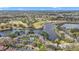 Expansive aerial view of a community featuring a pristine lake, golf course, and ample parking at 615 Midway Dr # B, Ocala, FL 34472