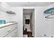A bright bathroom featuring a white vanity with open shelving, a toilet, and a shower at 615 Midway Dr # B, Ocala, FL 34472