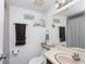 A well-lit bathroom with decorative wall art, a pink countertop, and a large mirror at 615 Midway Dr # B, Ocala, FL 34472