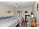 Bedroom featuring two twin beds, ceiling fan, decorative chest, and bright natural lighting at 615 Midway Dr # B, Ocala, FL 34472
