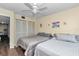 Bedroom featuring two twin beds, a ceiling fan, and double closet for ample storage at 615 Midway Dr # B, Ocala, FL 34472