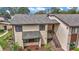 Two-story home with neutral paint, wood trim, and mature landscaping offering curb appeal and a welcoming exterior at 615 Midway Dr # B, Ocala, FL 34472