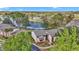 Scenic lake view property featuring well-maintained landscaping, mature trees, and a community overlooking the water at 615 Midway Dr # B, Ocala, FL 34472