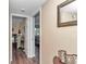 Hallway with wood floors leading to a sunlit bedroom creating a bright and open feel in the home at 615 Midway Dr # B, Ocala, FL 34472