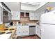 Bright kitchen featuring white cabinets, a yellow oven, and modern appliances at 615 Midway Dr # B, Ocala, FL 34472