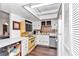 An efficient kitchen with white cabinets, a yellow oven, and natural light from a skylight at 615 Midway Dr # B, Ocala, FL 34472