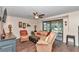 Inviting living room featuring neutral walls, ceiling fan, and glass sliding doors to the porch at 615 Midway Dr # B, Ocala, FL 34472