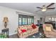 Inviting living room featuring neutral walls, ceiling fan, and views to the water at 615 Midway Dr # B, Ocala, FL 34472