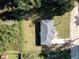 Overhead view captures the home's position on the lot, near trees, with a driveway and yard at 622 Nw 56Th Ave, Ocala, FL 34482