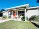 Inviting front entrance with vibrant door, patio seating and manicured landscaping at 622 Nw 56Th Ave, Ocala, FL 34482