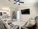 Comfortable living room with modern ceiling fan, TV, and open view to kitchen at 622 Nw 56Th Ave, Ocala, FL 34482