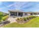 Exterior back of the home with screened in patio and beautiful landscaped yard at 7908 Sw 89Th Cir, Ocala, FL 34481