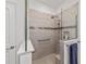 Walk-in shower features upgraded tile, glass surround, and built-in niche at 7908 Sw 89Th Cir, Ocala, FL 34481